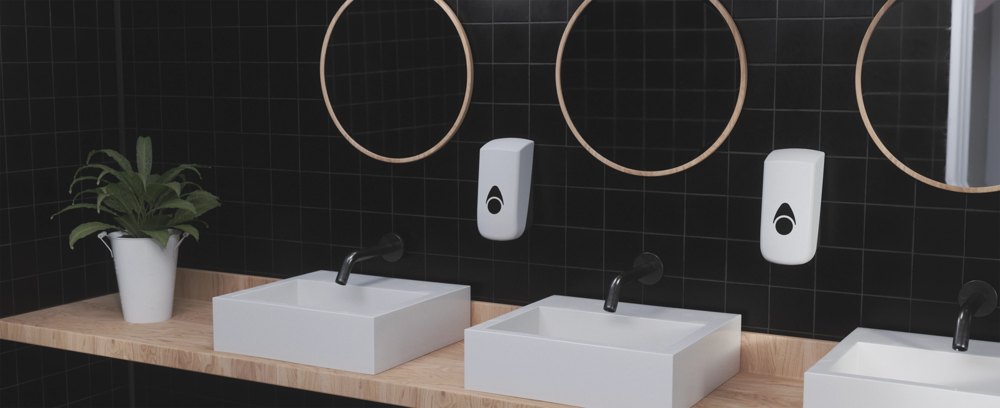 Commercial washroom space. Recycled plastic soap/liquid/foam dispensers hanging over sink. Myriad soap dispenser.